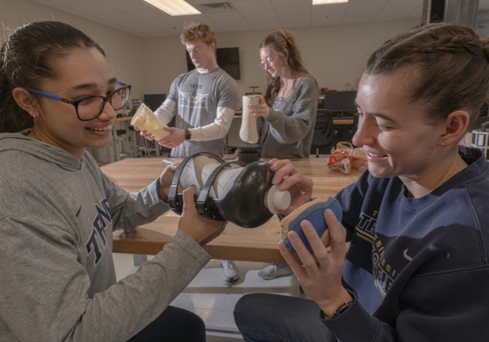four students work on a waterproof prosthetic device