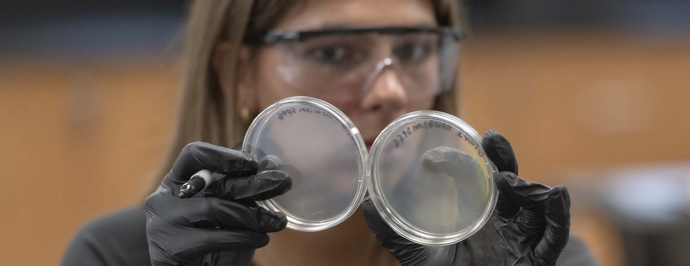 Student with petri dishes