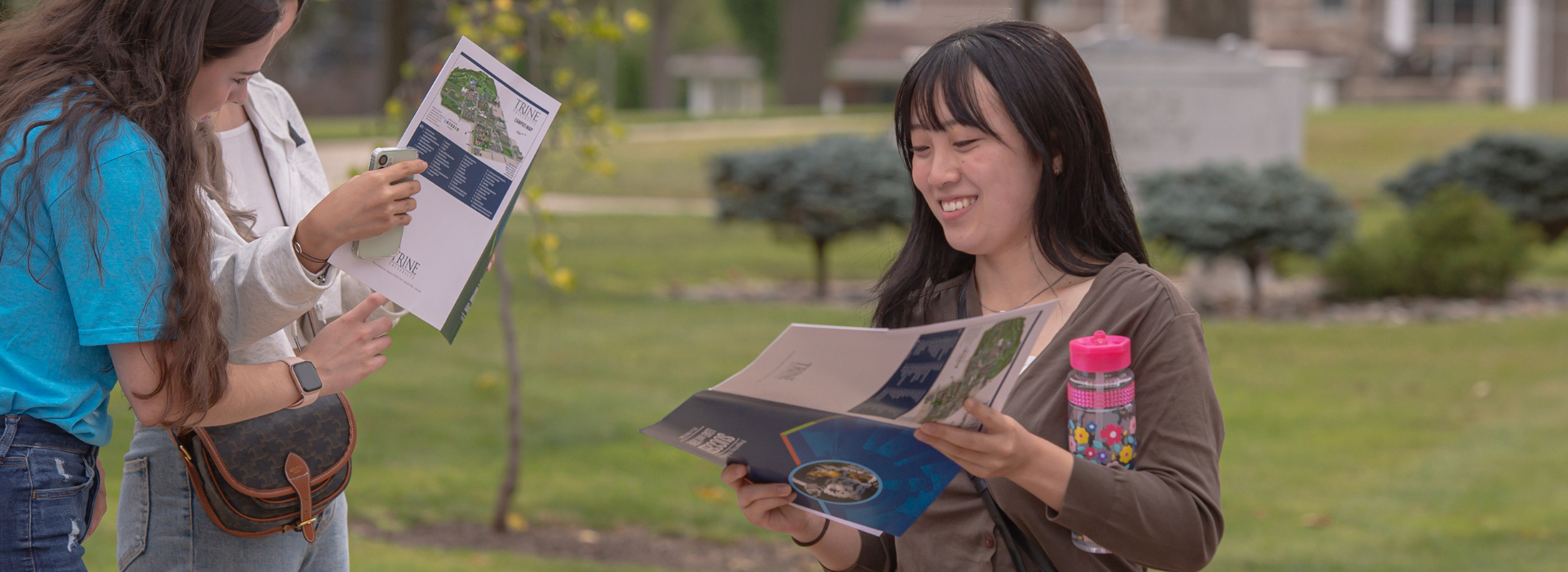 student reading a campus map