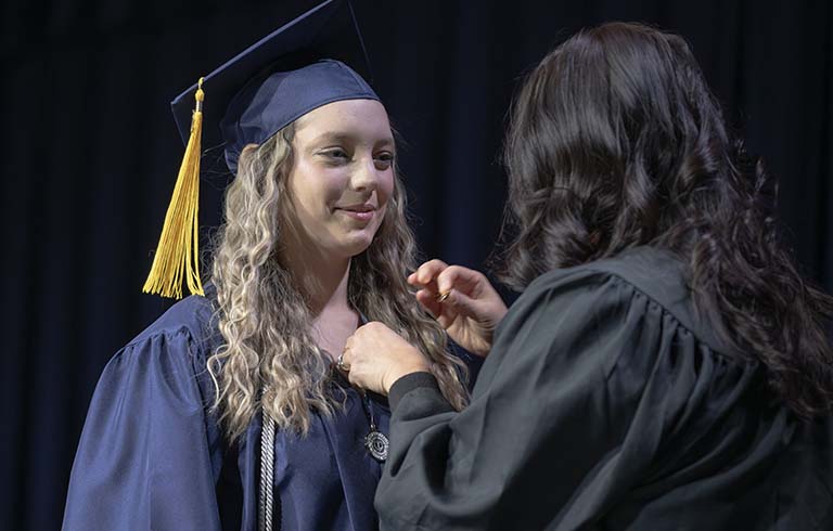 Student getting pinned at BCHP Commencement