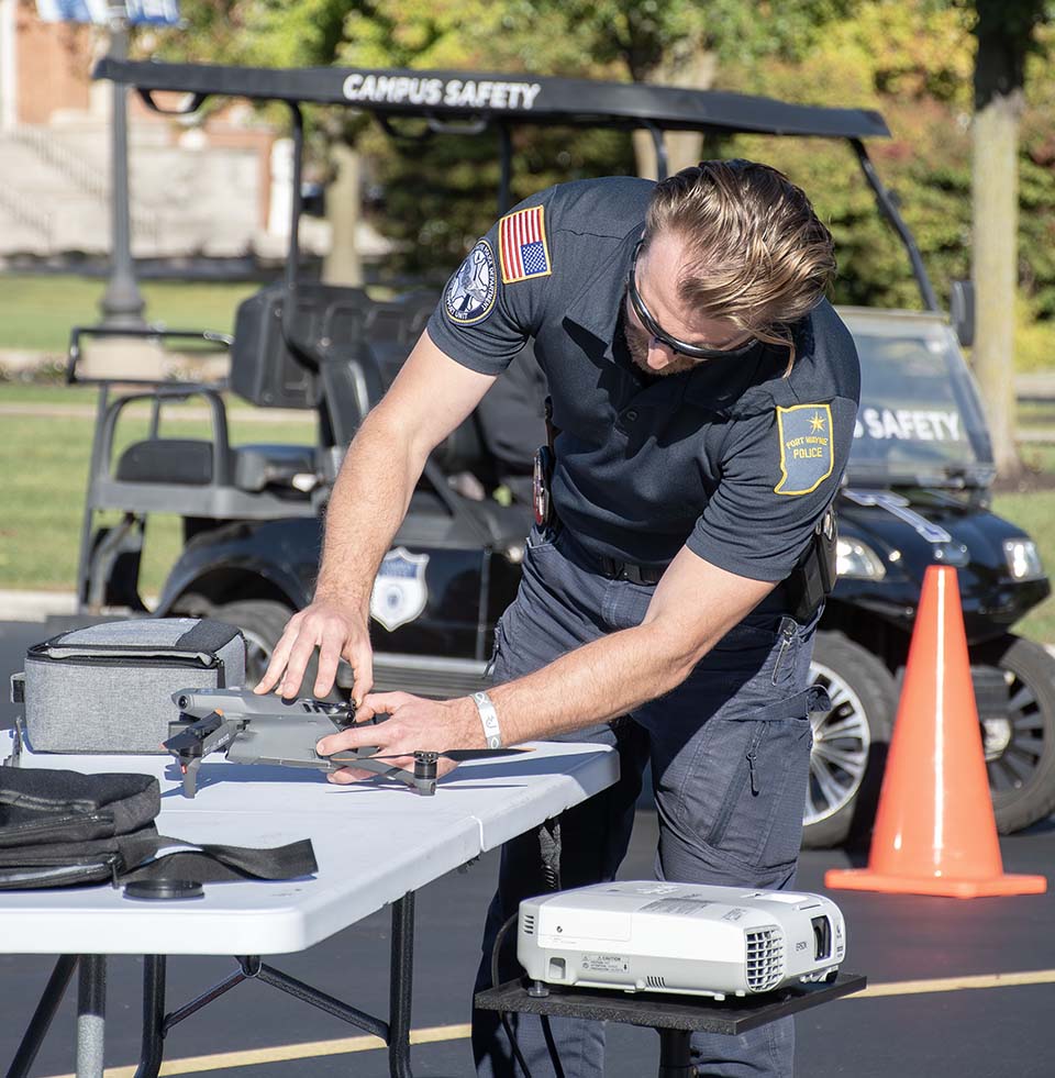 Police officer preparing drone for flight