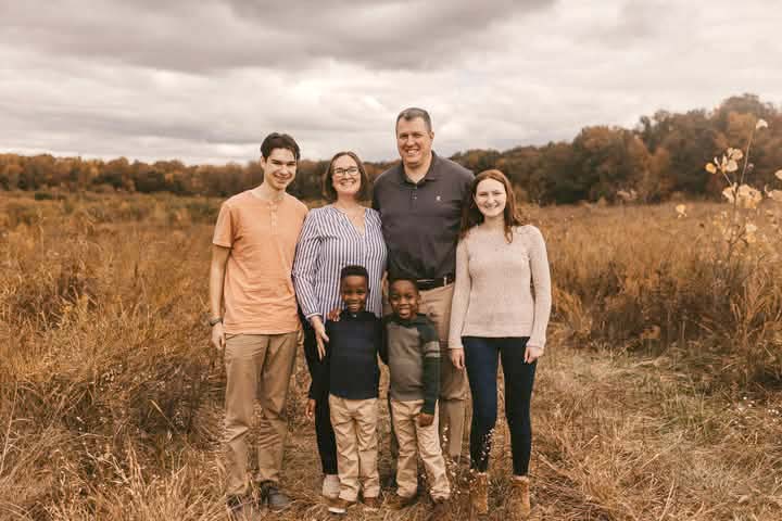 Family standing near field