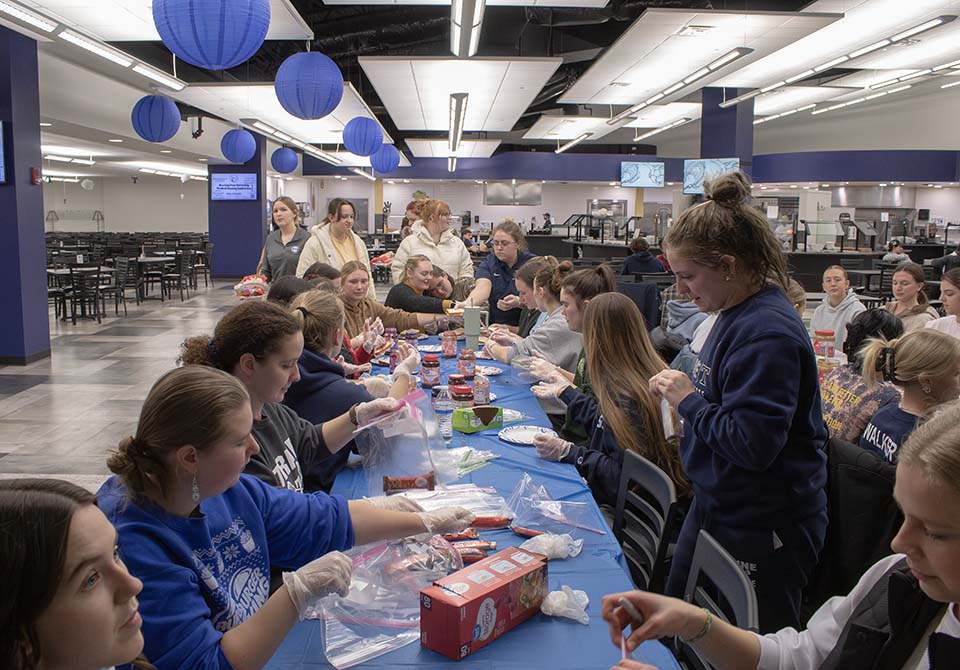 Students making PBJ sandwiches