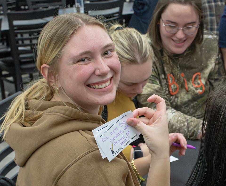 Student with notes of encouragement