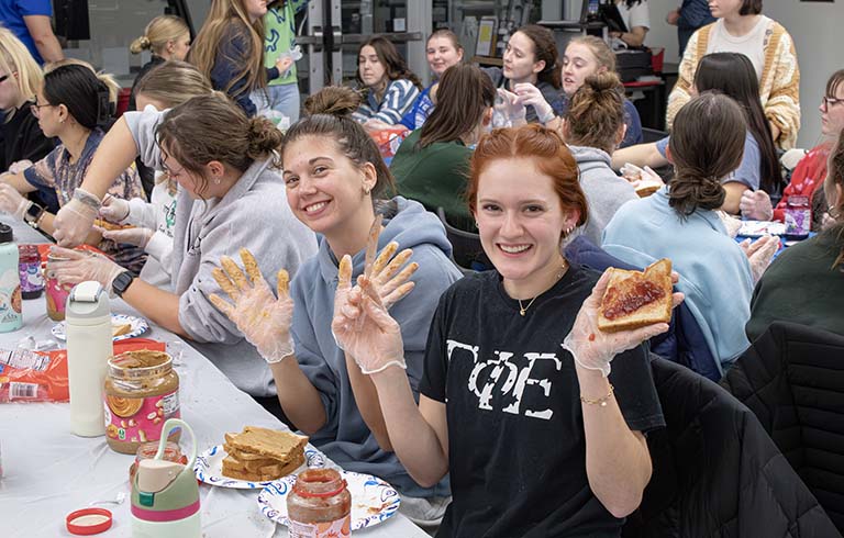 Students making PBJ sandwiches