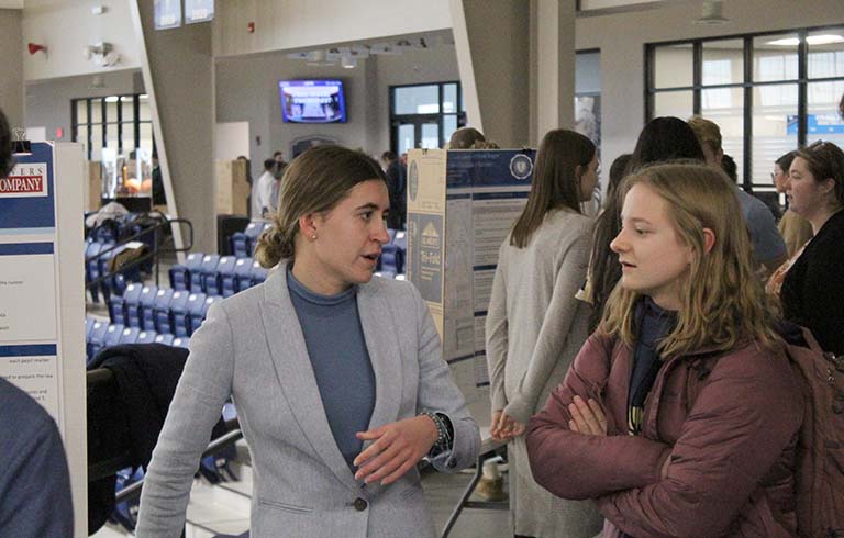 Student describing a project to another student