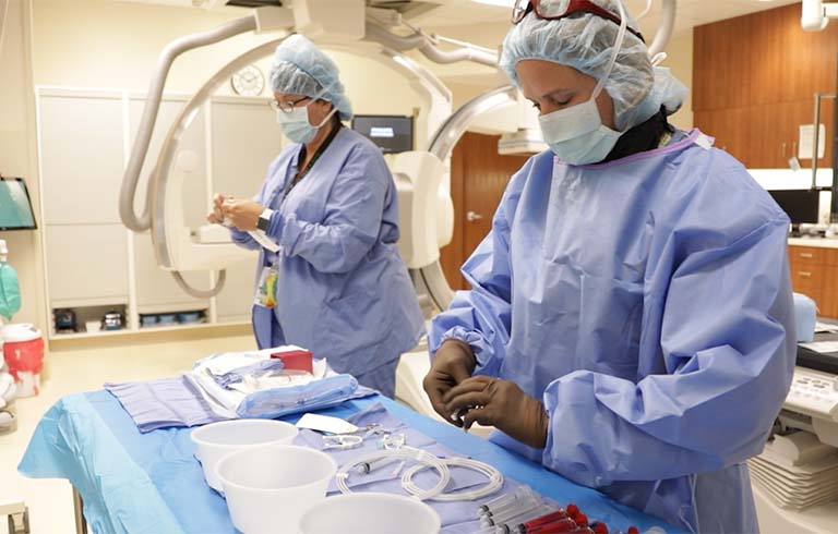 Surgical technologists in operating room
