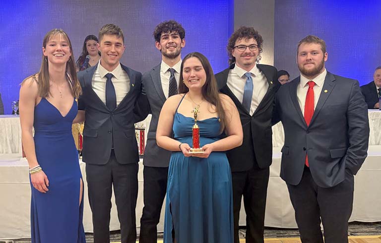 Six students with trophy