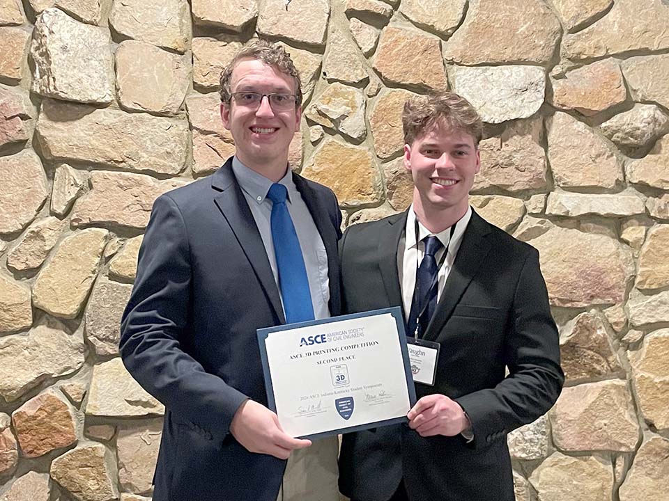 Two students with certificate