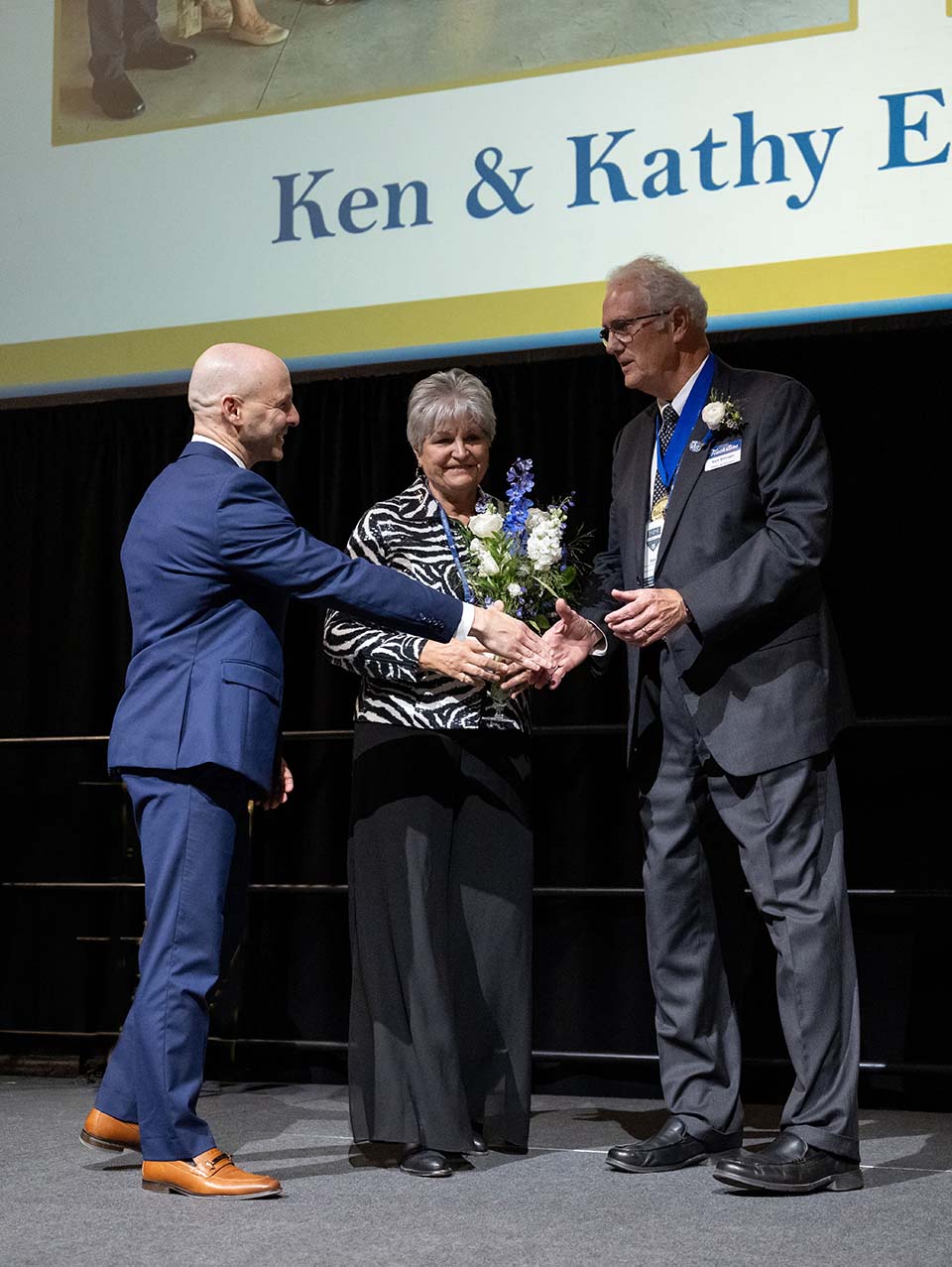 Dr. Kline reaching out hand to Ken Ehinger as Kathy watches