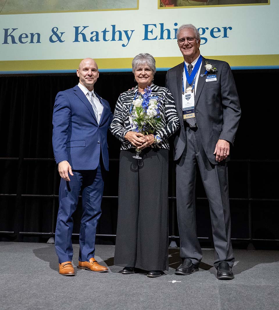 Dr. Kline, Kathy Ehinger holding crystal award, and Ken Ehinger