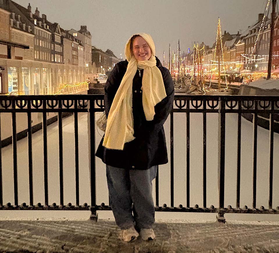 Grace Larson stands in front of the iconic outlook of Nyhavn in Copenhagen, Denmark. 