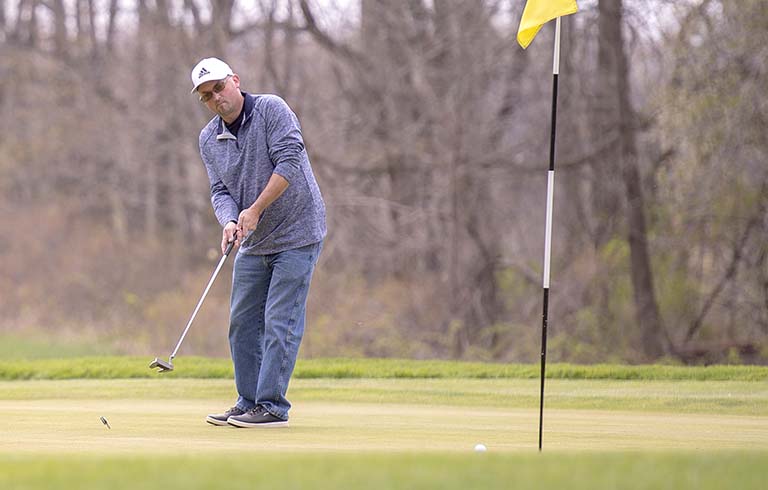 Golfer attempting a putt