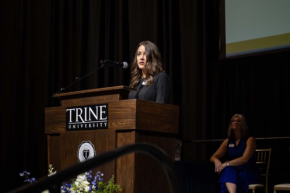 Angie Logan speaking at podium