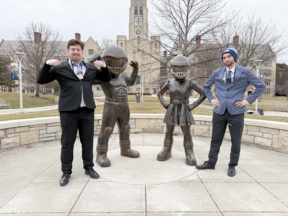 Jacob Seier and Carson Sickmiller with Rocky and Rocksy statues at 
